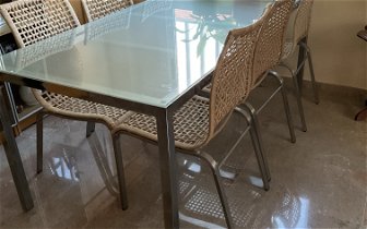 For sale: Glass topped dining table and six chairs