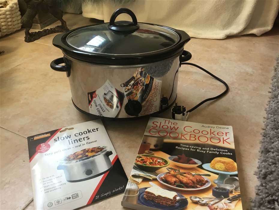 For sale: Crockpot Slow Cooker. Includes Slow Cooker Liners & Cookbook