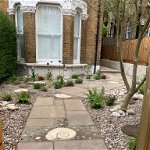 Front garden for young family. New gate way made and decorative path way added with ammonites.
