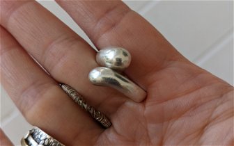 Found: 3 silver(?) rings, one with germ stone