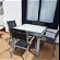 For sale: Extendable glass-topped iron table and 6 matching chairs
